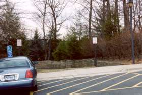 Turn right onto the sidewalk at the end of the parking lot and then left onto the asphalt trail away from the lot.