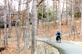 The short and long loops join where the bicyclist is shown. Follow on the trail the bicyclist is on curving to the left down the hill.