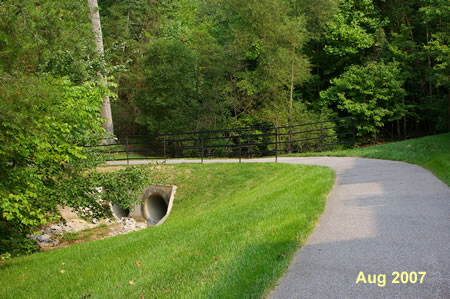 The trail makes a U turn as it crosses a culvert.