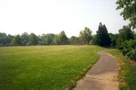 The path follows along the side of a baseball field.