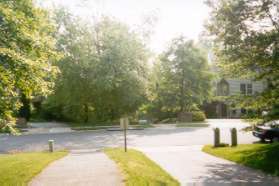 The path follows the driveway to Grenwich Point Rd.  The path starts on the other side to the right of the storm sewer.