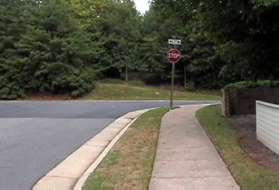 The sidewalk reaches North Village Rd.  Cross that road and turn left onto the asphalt trail on the other side.