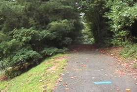 The asphalt trail climbs a short hill.