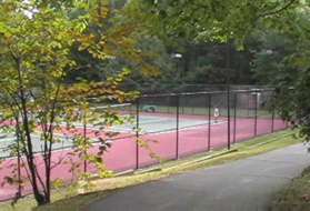 The trail passes tennis courts on the left.