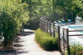 Both paths rejoin at the Lake Thoreau pool.  Follow the path between the pool and the parking lot.