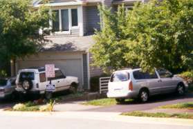 The trail crosses the road and goes between the houses shown.