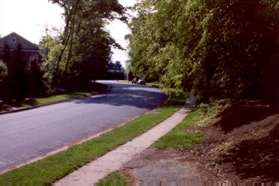 Continue on the sidewalk along Fairway Dr. in the same direction as the asphalt path was going.