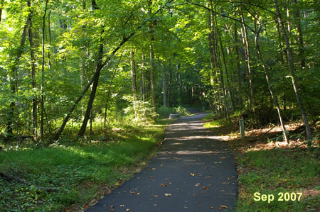 After some distance an asphalt trail intersects from the right.  Turn and follow this trail up the hill.