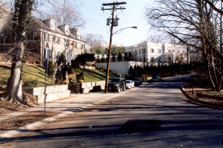 Rock Creek Dr turns sharply to the right at Normanstone Dr.  Continue on the sidewalk on the left side of the street with the woods on your right.