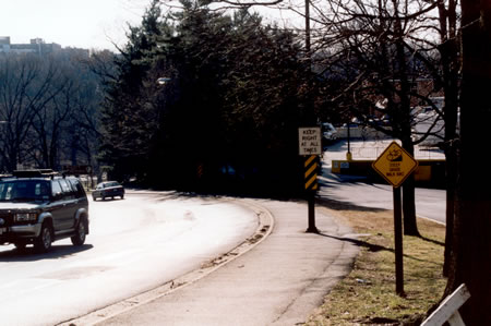 Turn right at the next street after passing the hotel and follow the asphalt path down the hill into Rock Creek Park.