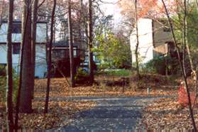 At the next trail intersection turn left to go up the hill.  Houses should be on your right.