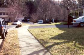 Turn left and follow the sidewalk along Quail Ridge Ct prior to the hedge.