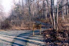 The sign marks a boundary between civic associations that maintain the path.
