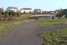 After several turns the path comes to a play area on the right.  On the other side of the bridge there is a basketball court.  Turn to the right after crossing the bridge.