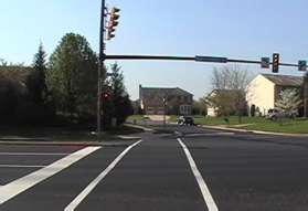 Cross Sunrise Valley Dr using the crosswalk from the bus terminal..