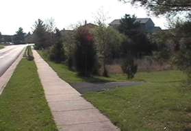 A wide asphalt trail intersects from the right.