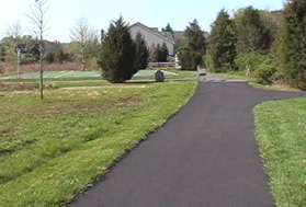 Asphalt trails intersect from the right and left.  Take the asphalt trail to the left.
