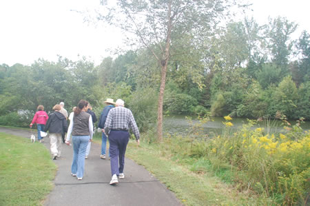 A paved trail on the north end of the pond.