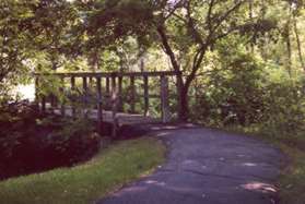 The trail crosses a bridge over a side creek.