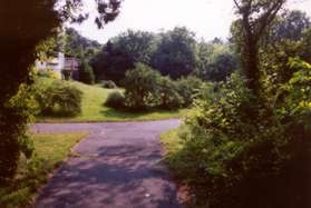 A paved trail intersects from the left. Go to the right.