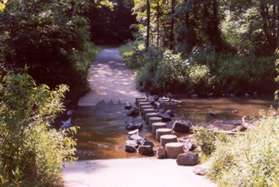 The trail crosses Sugarland Run on concrete columns.