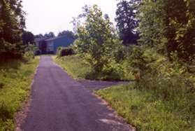A paved trail intersects from the right. Continue straight on the present trail. The next street intersection is the starting point on this walk.