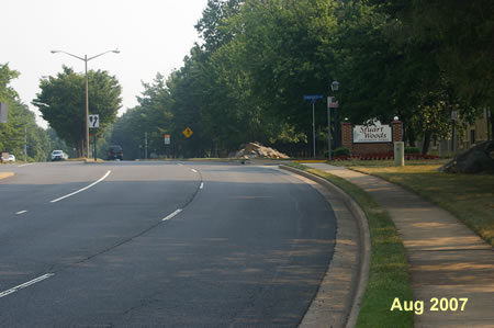 Follow the sidewalk with the Stuart Woods Apartments on the right.  Continue past the apartments.