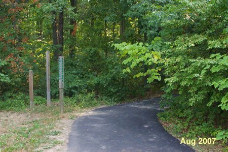 Turn right to follow the asphalt trail into the woods.