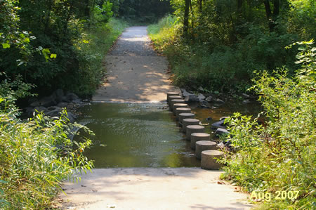 The trail crosses Sugarland Run on columns.