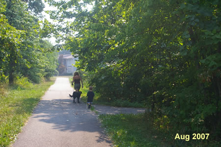 An asphalt trail intersects on the right.  Continue straight on the present trail.