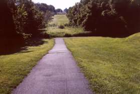 The trail follows the pipeline down the hill and turns left at the next trail intersection.  The Fairfax Co Pkwy can be seen in the distance.