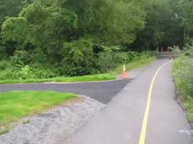 At the bottom of the hill turn left onto the intersecting paved trail.