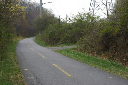 After walking a short distance on the bike trail turn right on the intersecting asphalt trail and walk up the hill.