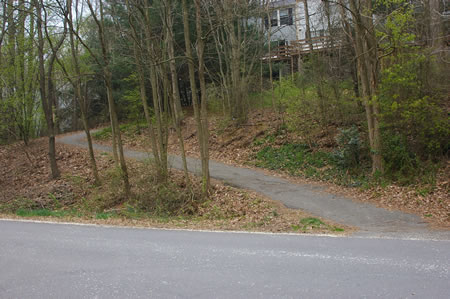 Turn left at the intersection with Harpers Square Ct. and follow the asphalt trail up the hill on the other side of Barton Hill Rd.