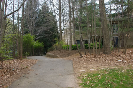 The trail passes homes as it continues to climb the hill.