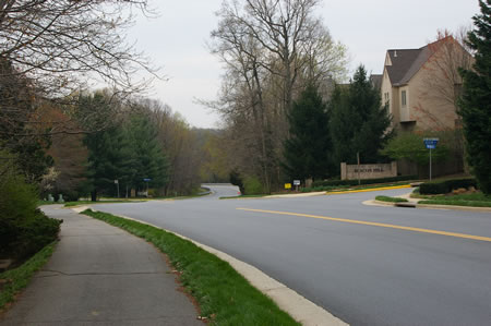 At the next intersection turn right to cross Twin Branches Rd. Then turn left to follow the concrete sidewalk along that road.