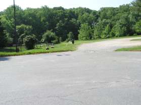 Walk to the end of the parking lot and take the path to the right of the train station.