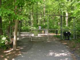 Pass through the pedestrian gate on the left side of the trail.